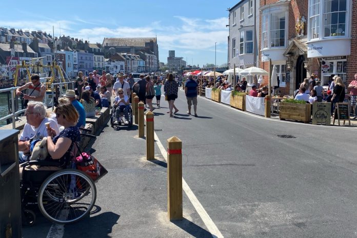 Bars and restaurants in Weymouth Harbor are charged with blocking sidewalks

